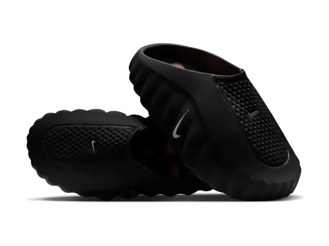 Black Nike Mind 001 mules with perforated uppers and silver Swooshes